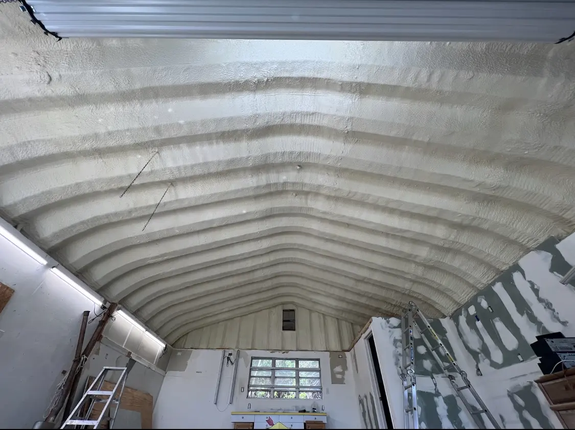 Spray polyurethane foam applied to the underside of a metal roof deck in Aldine